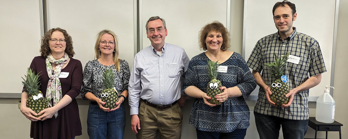 Faculty members Holly Wehmeyer, Michelle Cox, Melissa Layman-Guadalupe, and Dario Rodriguez pose with David Wright and pineapples to signify their graduation from ATLS. Dodd also holds a certificate.
